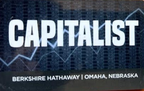 Official Berkshire Hathaway 'Capitalist' card from the annual shareholder meeting in Omaha, Nebraska, featuring a stock market ticker background